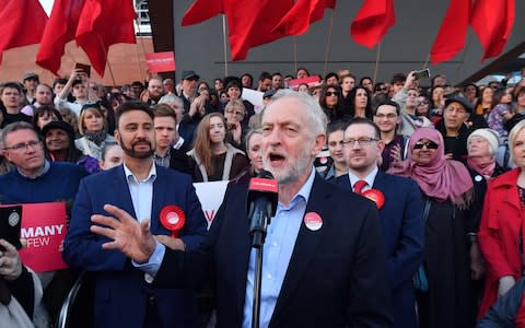 Jeremy Corbyn at a Momentum rally in Manchester speaking into a microphone - Credit: Anthony Devlin/Getty Images