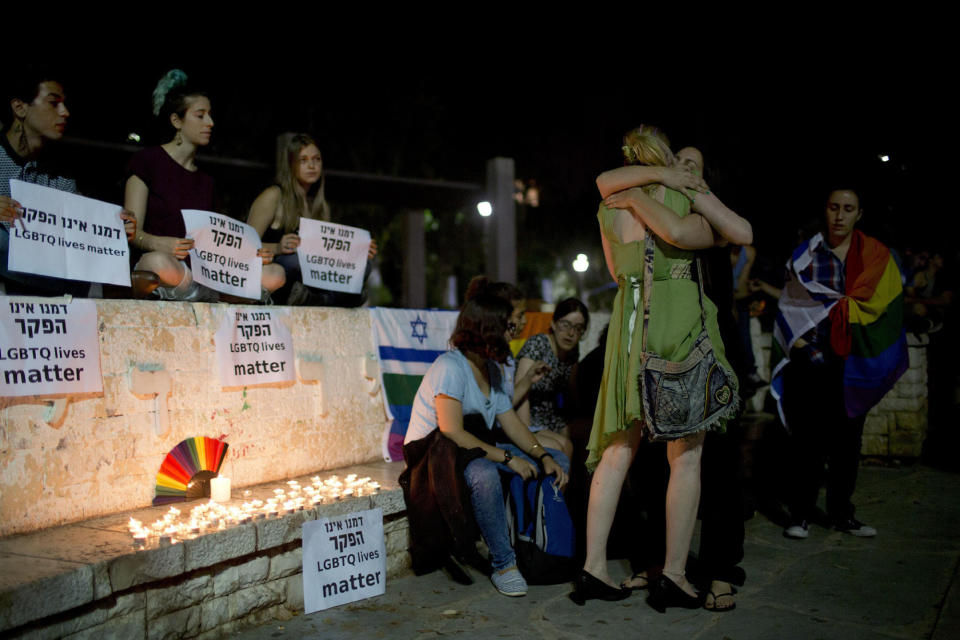 <p>Members LGBT community light candles in solidarity with Florida’s shooting attack victims in Tel Aviv, Israel, June 12, 2016. (AP Photo/Oded Balilty) </p>