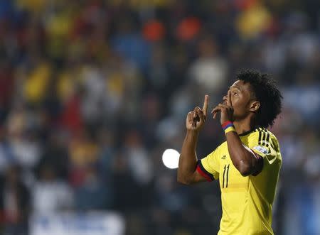 Colombia's Juan Cuadrado celebrates after scoring in penalties after the end of regulation play against Argentina in their Copa America 2015 quarter-finals soccer match at Estadio Sausalito in Vina del Mar, Chile, June 26, 2015. REUTERS/Marcos Brindicci/Files