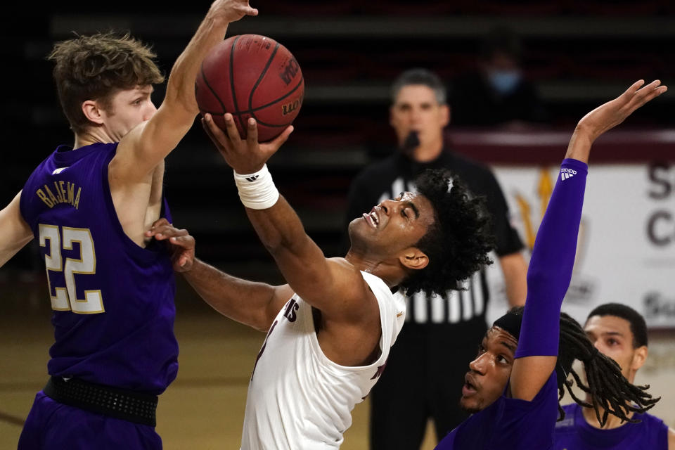 Arizona State guard Remy Martin (1) drives between Washington guard Cole Bajema (22) and forward Hameir Wright during the first half of an NCAA college basketball game, Thursday, Feb. 25, 2021, in Tempe, Ariz. (AP Photo/Rick Scuteri)