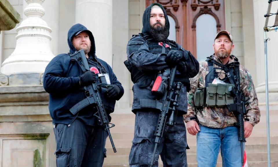 Michael Null, left, one of the men charged for the plot to kidnap governor Gretchen Whitmer, takes part in an anti-lockdown rally at the Michigan state capitol in April.