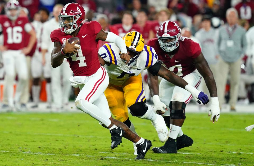 Alabama quarterback Jalen Milroe (4) scrambles up the field against the LSU defense during the second quarter at Bryant-Denny Stadium.