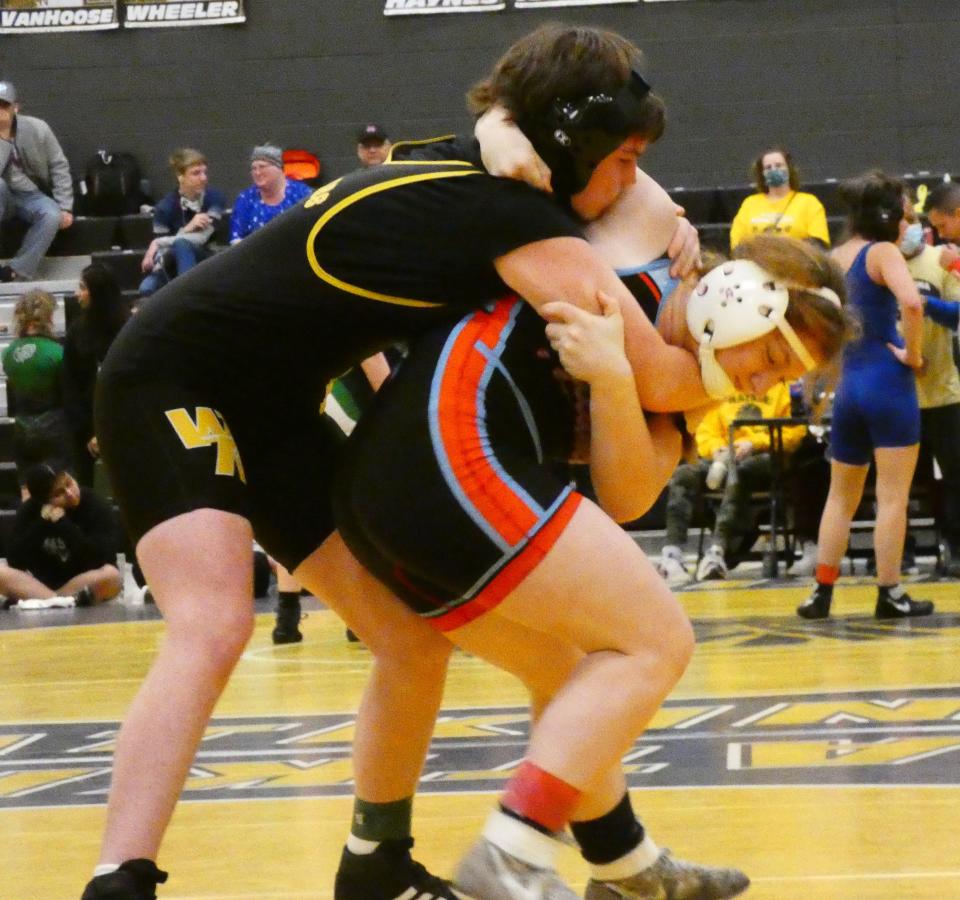 Watkins Memorial senior Lauryn Bickle fights off a throw attempt from Alliance freshman Abigail Mozden at 135 pounds during Watkins' first girls high school wrestling tournament Wednesday, Dec. 29, 2021.