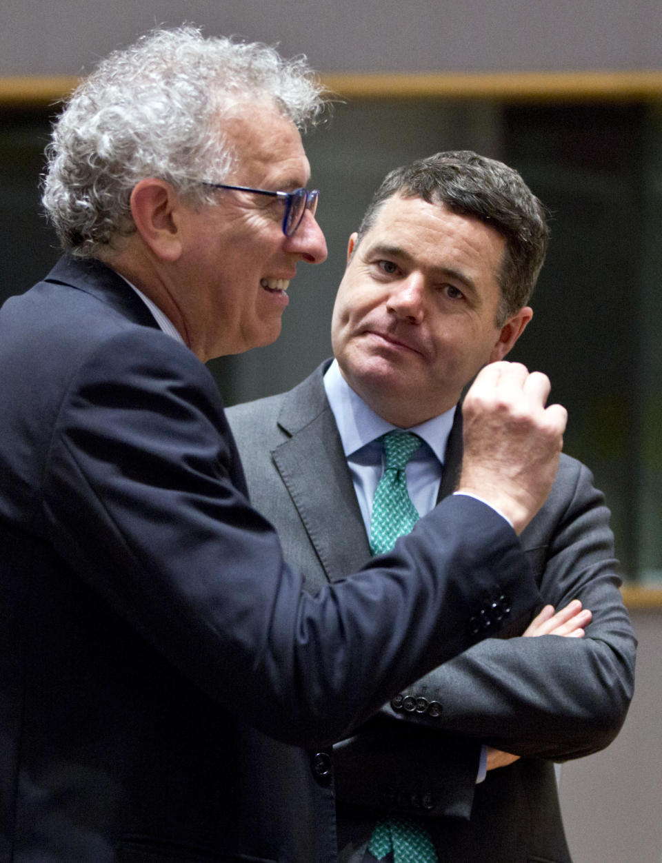 FILE - In this Friday, May 25, 2018 file photo, Luxembourg's Finance Minister Pierre Gramegna, left, speaks with Irish Finance Minister Paschal Donohoe during a meeting of EU finance ministers at the Europa building in Brussels. The powerful group of countries using Europe's single currency will choose a new president on Thursday, July 9, 2020, with three candidates vying for the challenging task of leading the 19-nation bloc out of the deepest economic recession in decades. The candidates for Eurogroup president are Spain's Economy Minister Nadia Calvino, Irish Finance Minister Paschal Donohoe and Luxembourg's Finance Minister Pierre Gramegna. (AP Photo/Virginia Mayo, File)