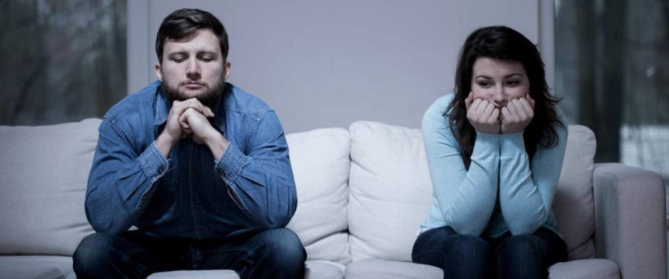 Couple after argument sitting on the sofa