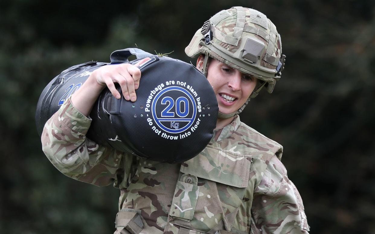 Lance Corporal Nicola Cotton of the Scots Guards, demonstrates the repeated lift and carry stage in the British Army's New Physical Employment Standards - PA