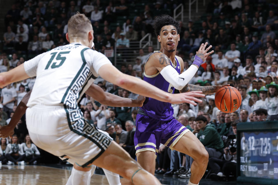 James Madison's Terrence Edwards Jr., right, drives against Michigan State's Carson Cooper (15) during the first half of an NCAA college basketball game, Monday, Nov. 6, 2023, in East Lansing, Mich. (AP Photo/Al Goldis)