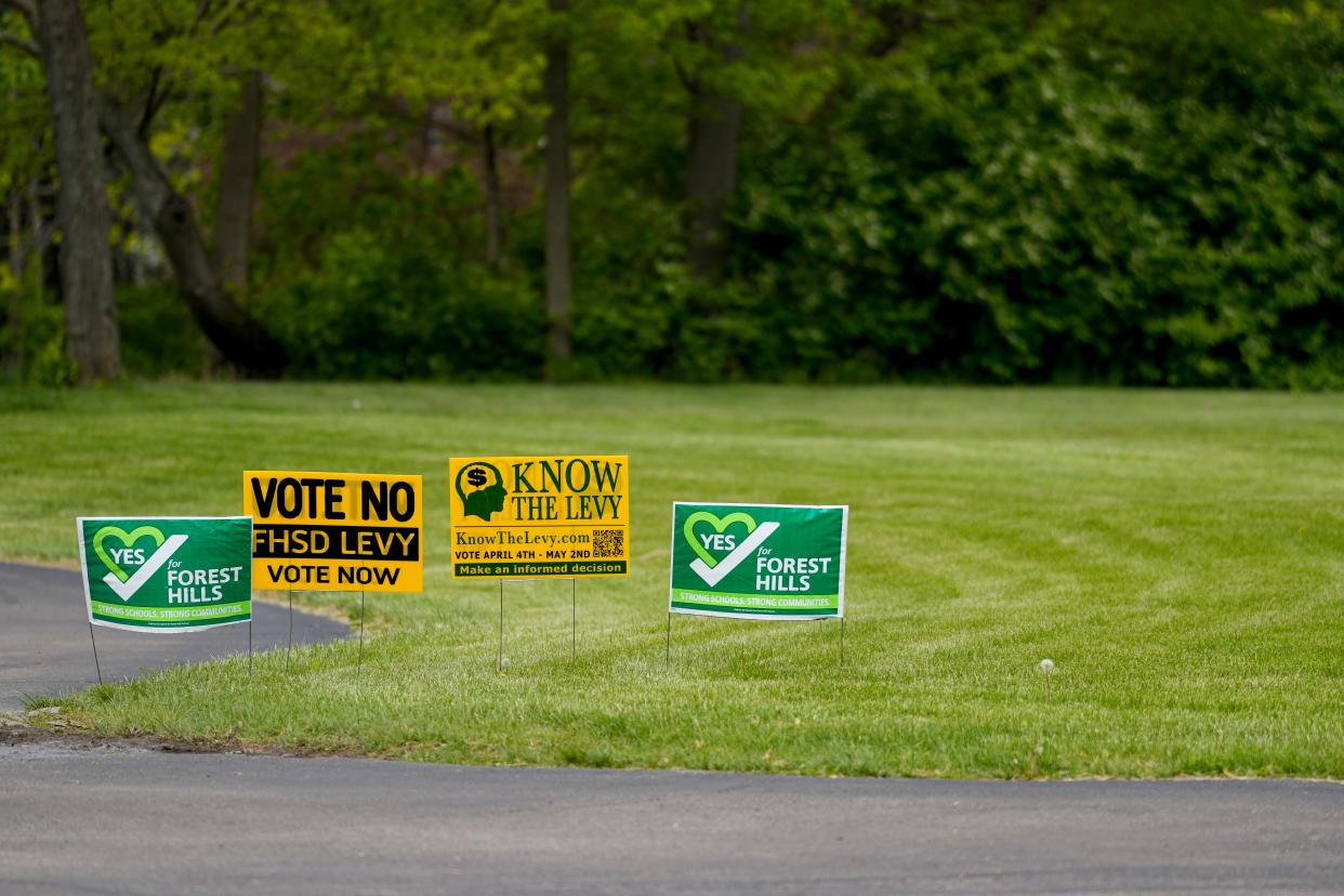 Political signs, for and against the Forest Hills school levy, stand outside the Lutheran Church of the Resurrection polling place in Anderson Township on Tuesday.