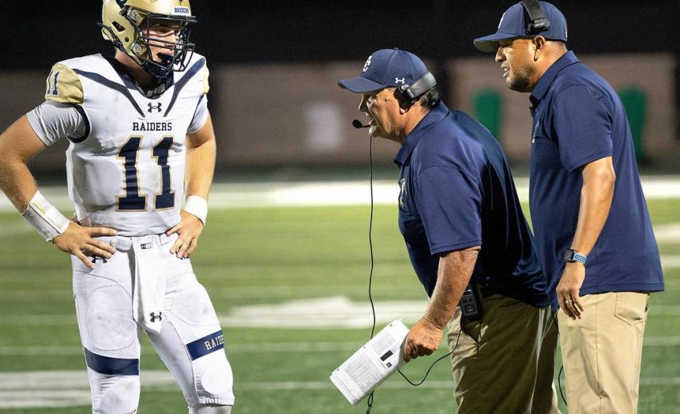 Central Catholic coaches Roger Canepa, middle, and Tim Garcia talk with quarterback Tyler Wentworth during the game with St. Mary’s in Stockton, Calif., Friday, August 25, 2023. St. Mary’s won the game 42-33.
