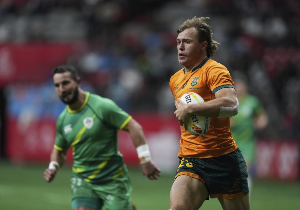 Australia's Darby Lancaster, front right, runs for a try against Ireland during a Canada Sevens rugby match in Vancouver, British Columbia, Saturday, March 4, 2023. (Darryl Dyck/The Canadian Press via AP)