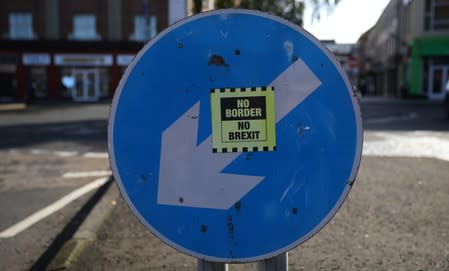 A 'No hard Border' poster is seen below a road sign on the Irish side of the border between Ireland and Northern Ireland near Bridgend Ireland