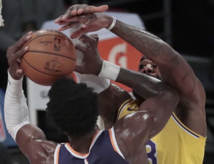 Los Angeles, CA, Tuesday, March 2, 2021 - Los Angeles Lakers forward LeBron James (23) blocks the shot of Phoenix Suns center Deandre Ayton (22) during first half action at Staples Center. (Robert Gauthier/Los Angeles Times)