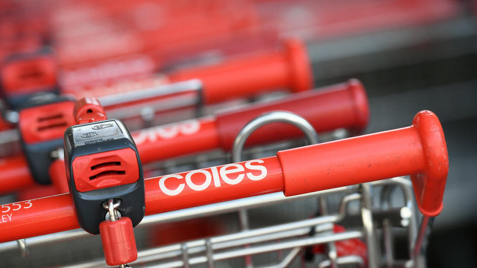 A photo shows a row of Coles trolleys.