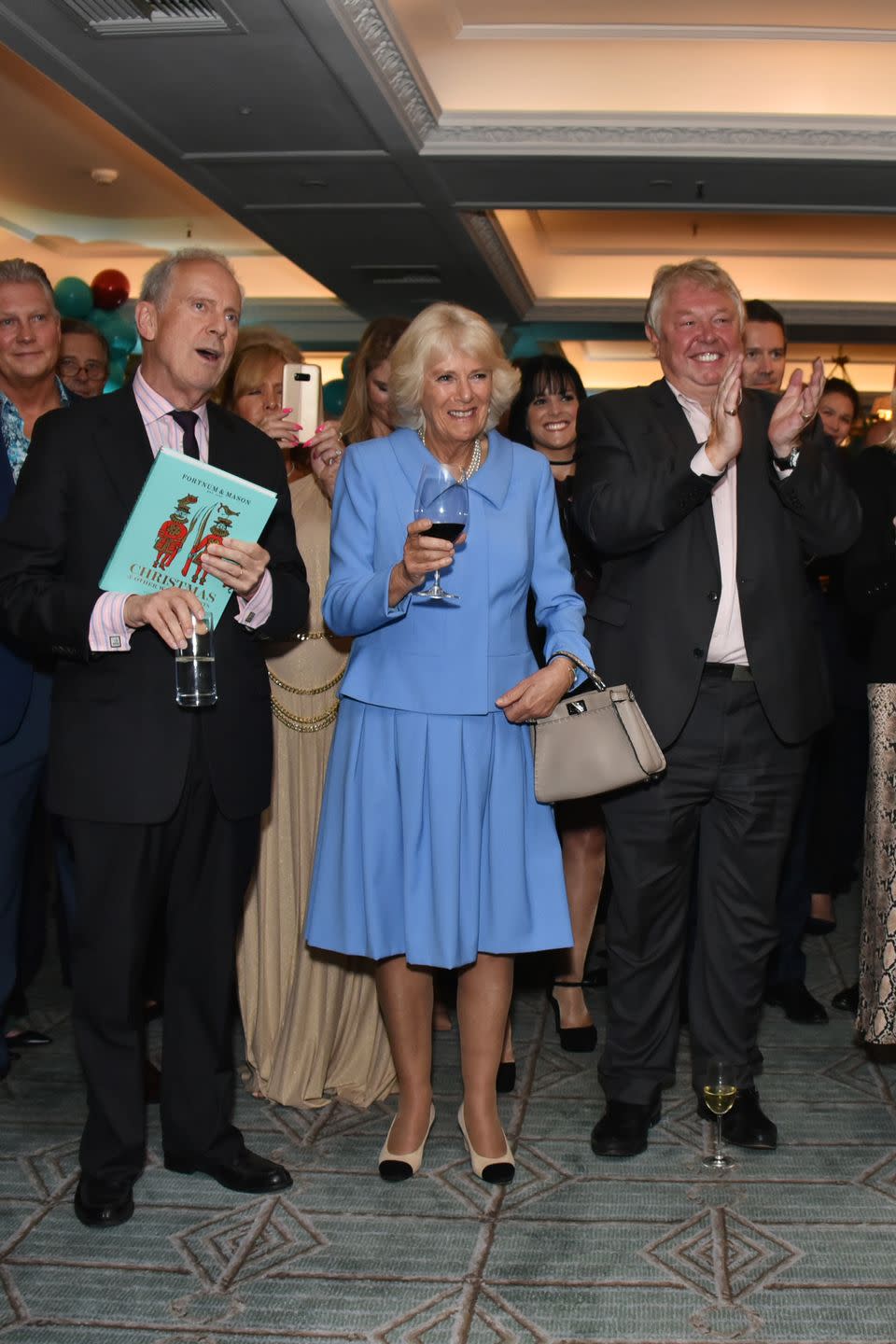 <p>Camilla Parker Bowles recycled a look from earlier this year while attending the launch of the <em>Fortnum & Mason Christmas & Other Winter Feasts </em>cookbook which was written by her son, <a href="https://www.townandcountrymag.com/society/tradition/a17008420/camilla-parker-bowles-children/" rel="nofollow noopener" target="_blank" data-ylk="slk:Tom Parker Bowles;elm:context_link;itc:0;sec:content-canvas" class="link ">Tom Parker Bowles</a>.</p>