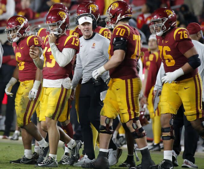 USC head coach Lincoln Riley talk with his players on the sideline during the fourth quarter against Notre Dame.