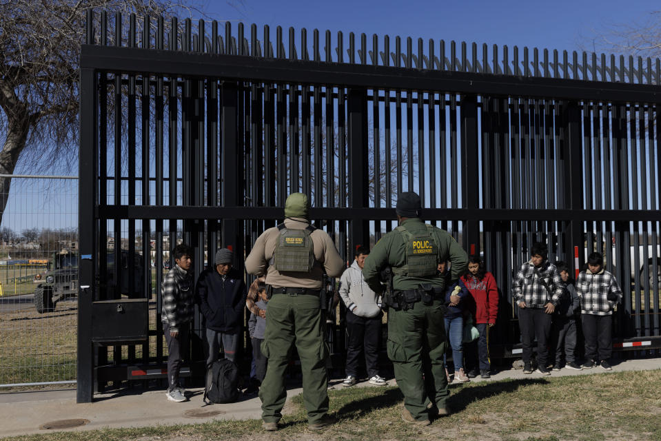 U.S. Border Patrol agents guard migrants that crossed into Shelby Park as they wait to be picked up for processing on February 4, 2024, in Eagle Pass, Texas. / Credit: Michael Gonzalez/Getty Images