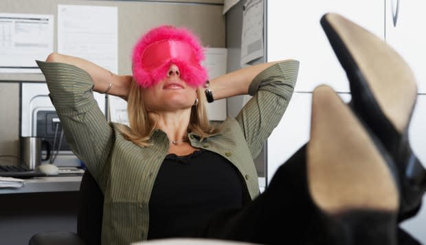 ARRHY3 Woman wearing eyemask in the office  Woman; wearing; eyemask; in; office; laziness; female; one; person; indoors; office;
