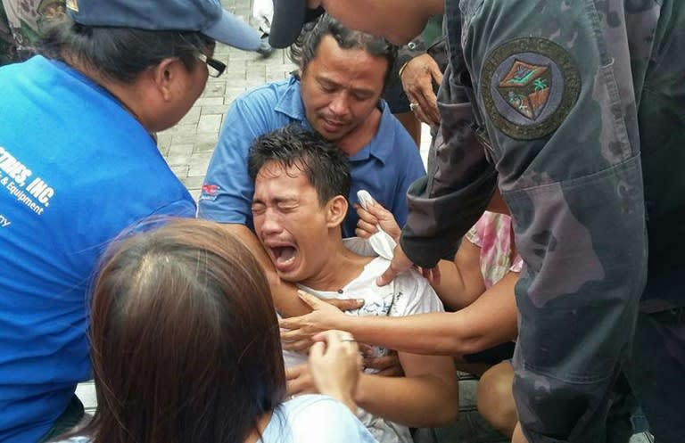 A survivor of the passenger ferry that capsized in rough waters sobs after being rescued on July 2, 2015 following the latest maritime tragedy to hit the Philippines