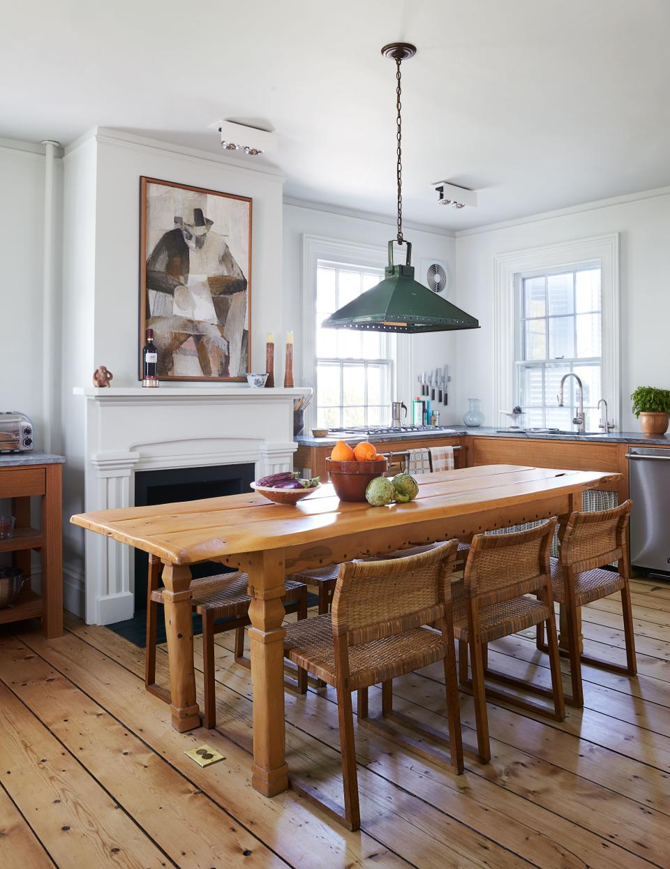 The kitchen features standing work tables in place of cabinetry; vintage pendant.