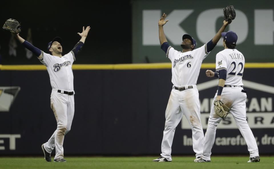 Milwaukee Brewers' Ryan Braun, Christian Yelich and Lorenzo Cain celebrate after Game 6 of the National League Championship Series baseball game against the Los Angeles Dodgers Friday, Oct. 19, 2018, in Milwaukee. The Brewers won 7-2 to tie the series at 3-3. (AP Photo/Matt Slocum)