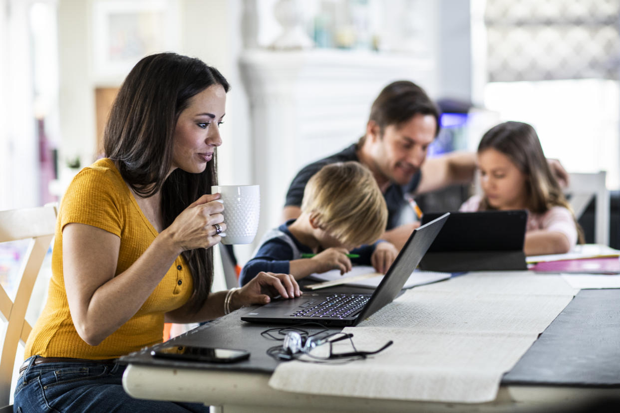 breadwinner Mother working from home while children attend school online