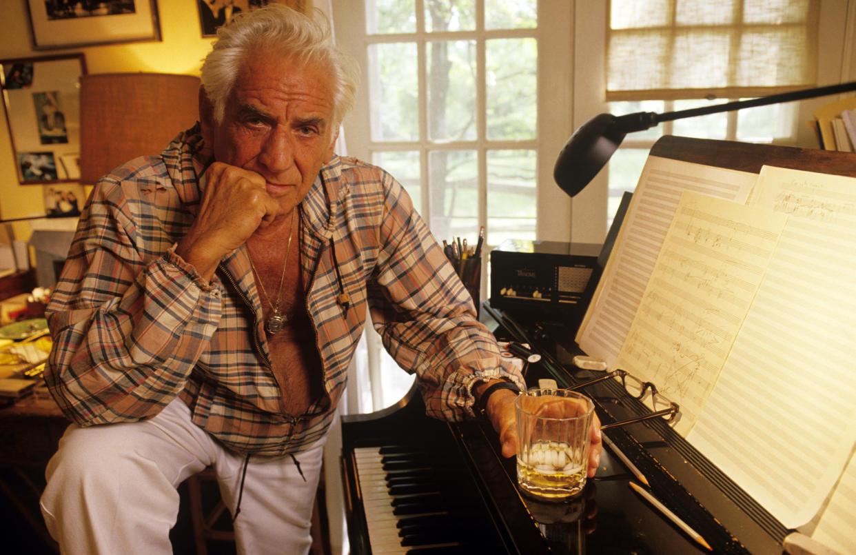 FAIRFIELD, CT - 1986:  Composer Leonard Bernstein poses near a piano in 1986 at Springate, his Fairfield, Connecticut home. Bernstein's most recognizable affiliation was as the longtime music director of the New York Philharmonic Orchestra. In addition, Bernstein was noted for writing the music for the highly acclaimed musical, West Side Story.  (Photo by Joe McNally/Getty Images)