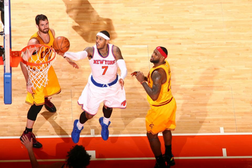 Carmelo Anthony gets between Kevin Love and LeBron James. (Getty Images)