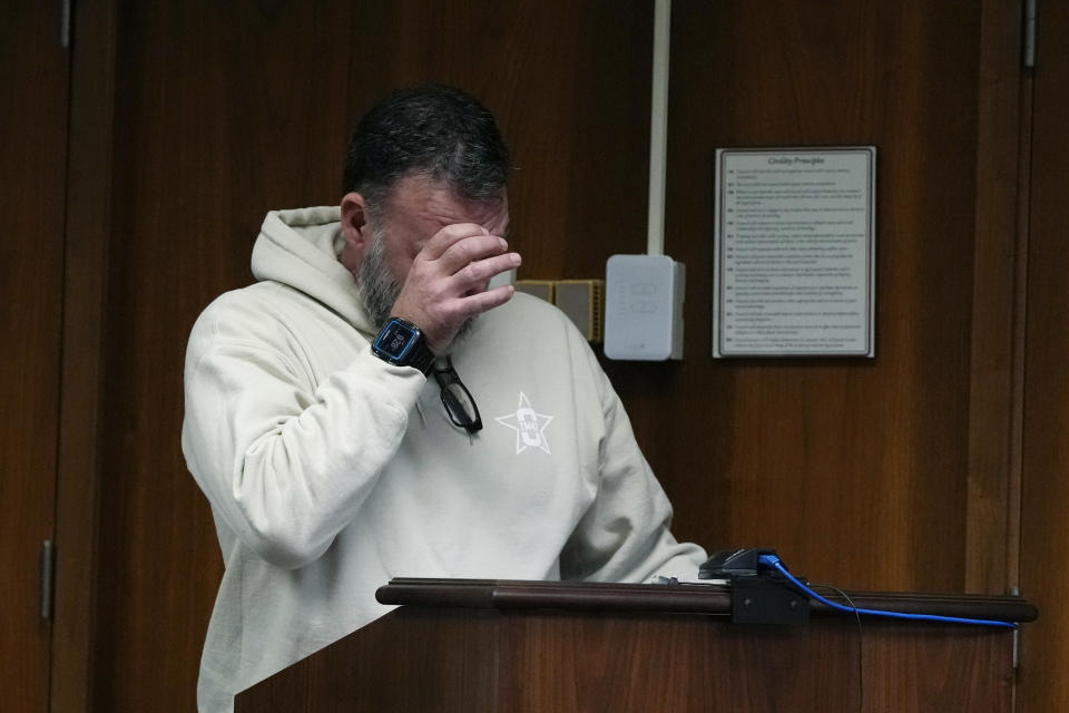 Buck Myre, the father of Tate Myre, wipes his eyes as he gives his victim impact statement, Friday, Dec. 8, 2023, in Pontiac, Mich. Parents of students killed at Michigan's Oxford High School described the anguish of losing their children Friday as a judge considered whether Ethan Crumbley, a teenager, will serve a life sentence for a mass shooting in 2021. (AP Photo/Carlos Osorio)