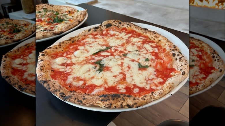 Margherita pizza pie on black table