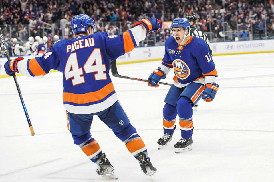 New York Islanders left wing Zach Parise (11) celebrates with his teammate New York Islanders centerman Jean-Gabriel Pageau (44) after scoring a goal during the extra period of an NHL hockey game against the Columbus Blue Jackets Saturday, Nov. 12, 2022, in Elmont, N.Y. New York Islanders won 4-3. (AP Photo/Eduardo Munoz Alvarez)