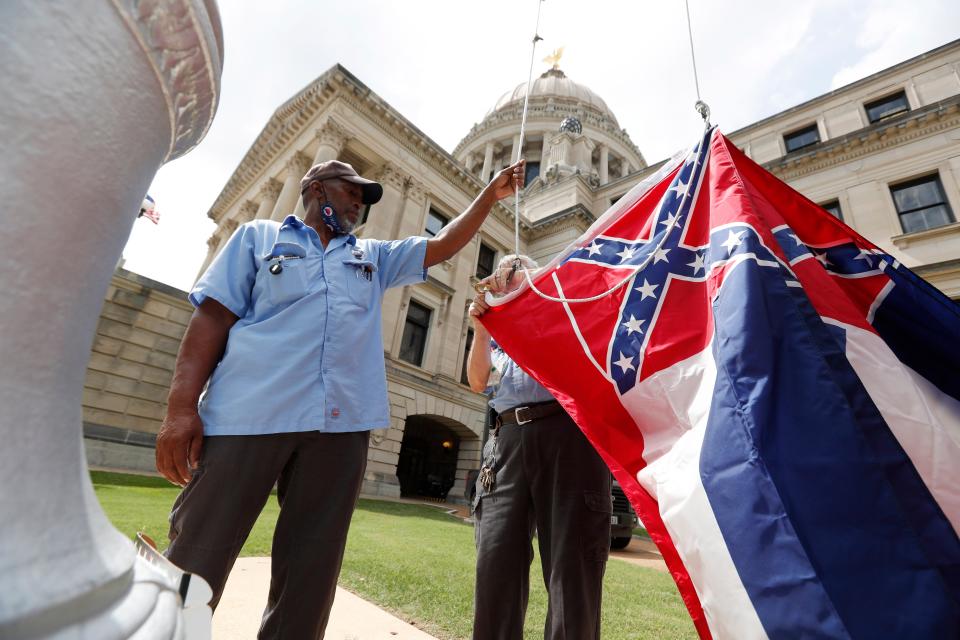 City of Tupelo Community Outreach Coordinator Marcus Gary takes down the State Flag of Mississippi that flew over the City Hall of Tupelo one last time June 29. Mississippi is retiring the last state flag in the U.S. that includes the Confederate battle emblem.