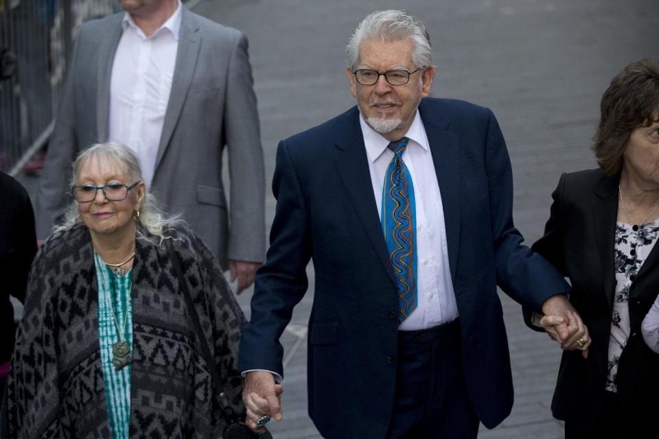 Veteran entertainer Rolf Harris and his wife Alwen Hughes, left, arrive at Southwark Crown Court in London, Tuesday, May 6, 2014. Harris is charged with nine counts of indecent assault and four counts of making indecent images of children. (AP Photo/Matt Dunham)