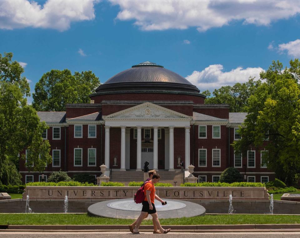 Students walk past Grawemeyer Hall on the campus of the University of Louisville on May 14, 2019.