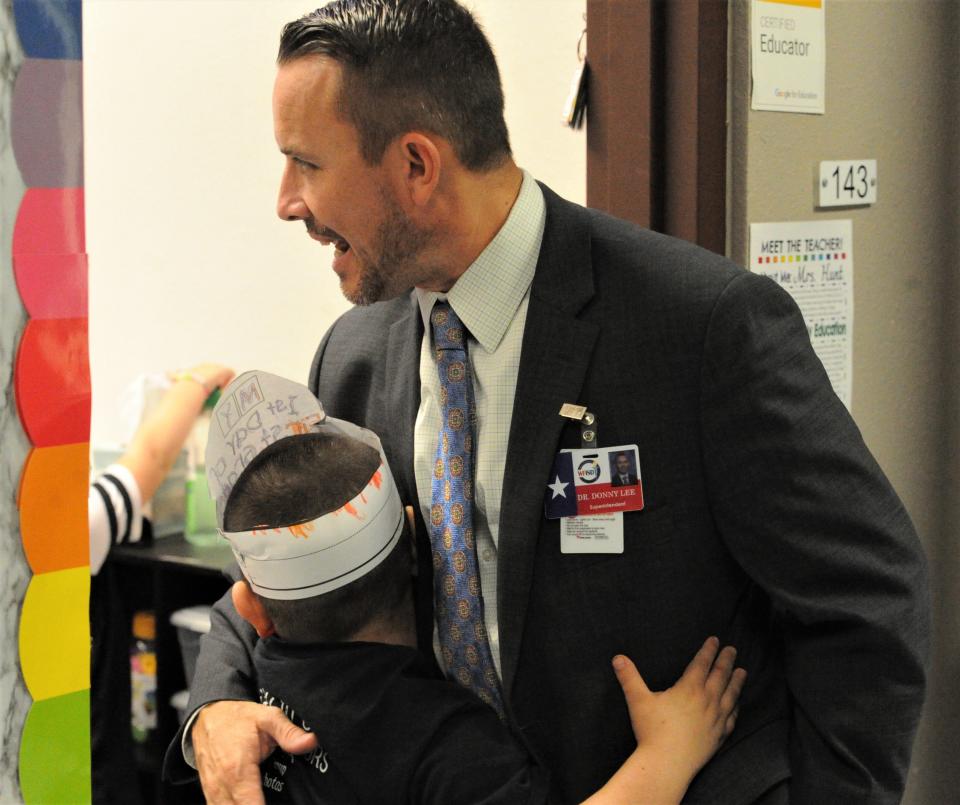 A Zundy Elementary School student greets WFISD Superintendent Donny Lee with a hug on the first day of school for WFISD students on Wednesday, August 17, 2022.