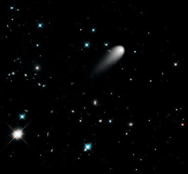 In this Hubble Space Telescope composite image taken in April 2013, the sun-approaching Comet ISON floats against a seemingly infinite backdrop of numerous galaxies and a handful of foreground stars. The icy visitor, with its long gossamer tail