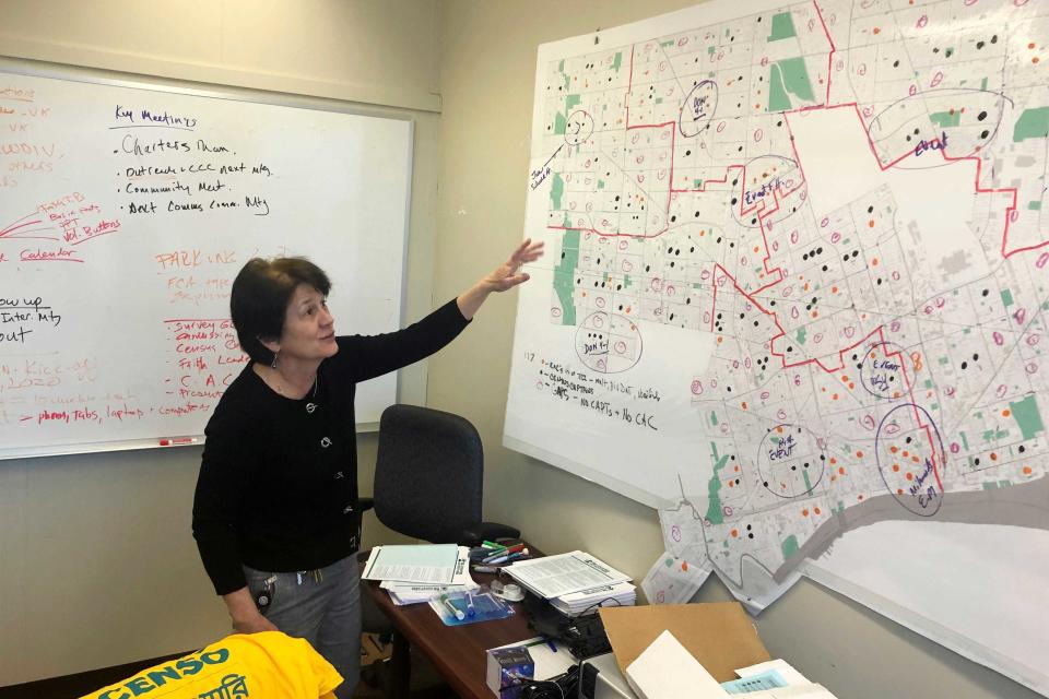 In this Nov. 22, 2020 photo, Detroit 2020 Census Campaign executive director Victoria Kovari looks over a Detroit map showing city neighborhoods that were under-counted in the 2010 census.