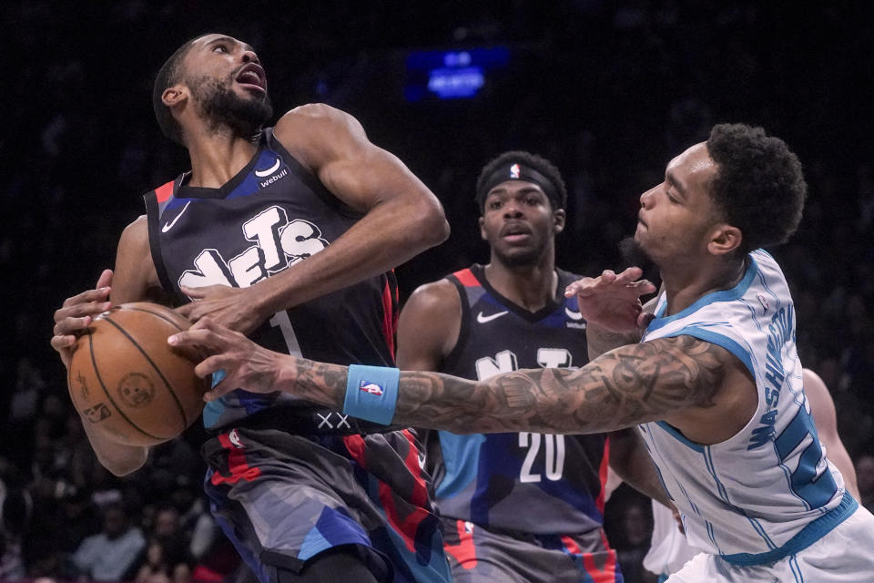 Charlotte Hornets' P.J. Washington, right, strips Brooklyn Nets' Mikal Bridges of the ball during an NBA basketball game, Thursday, Nov. 30, 2023, in New York. (AP Photo/Bebeto Matthews)