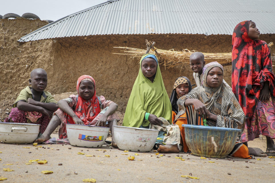 Children play and sell small foodstuffs on the street in the town of Jangebe, where more than 300 girls were abducted by gunmen on Friday from the the Government Girls Junior Secondary School, in Zamfara state, northern Nigeria Saturday, Feb. 27, 2021. Nigerian police and the military have begun joint operations to rescue the more than 300 girls who were kidnapped from the boarding school, according to a police spokesman. (AP Photo/Ibrahim Mansur)