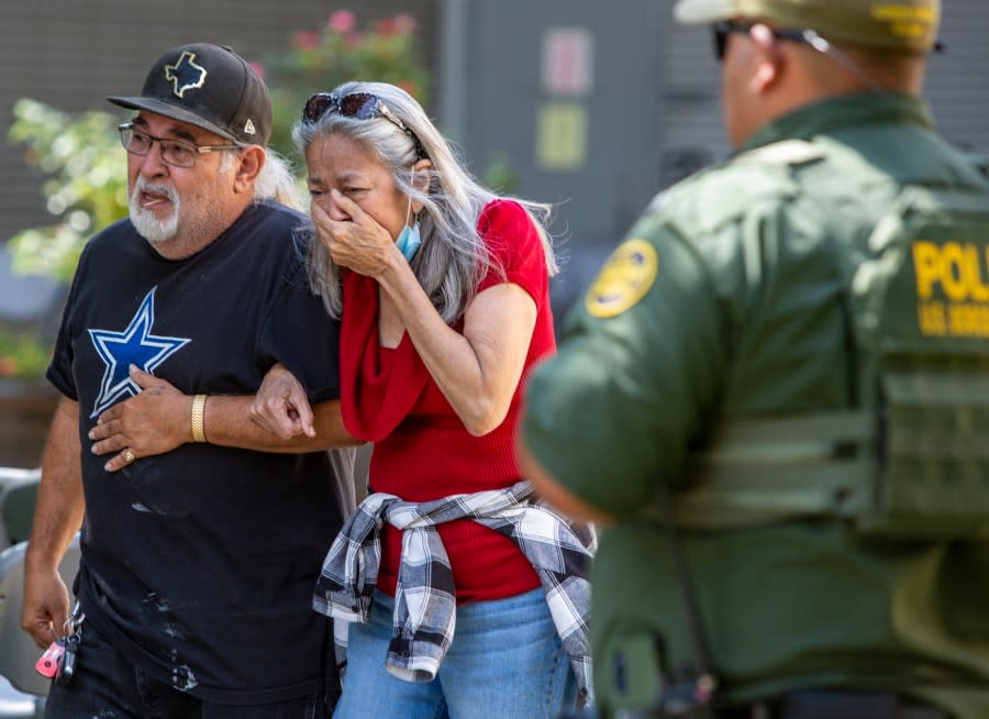 FILE – A woman cries as she leaves the Uvalde Civic Center, Tuesday May 24, 2022, in Uvalde, Texas, after a mass shooting. AA federal report into the halting and haphazard law enforcement response to a school shooting in Uvalde, Texas, was scheduled to be released Thursday, Jan. 18, 2024, reviving scrutiny of the hundreds of officers who responded to the 2022 massacre but waited more than an hour to confront and kill the gunman. (William Luther/The San Antonio Express-News via AP, File)