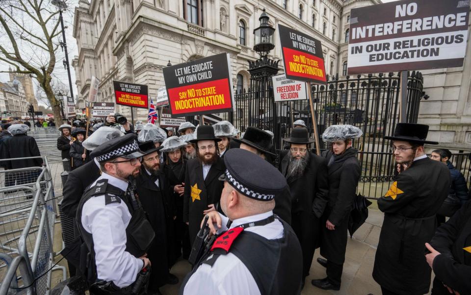 Members of the Orthodox Jewish community protest outside Downing Street today over education reform