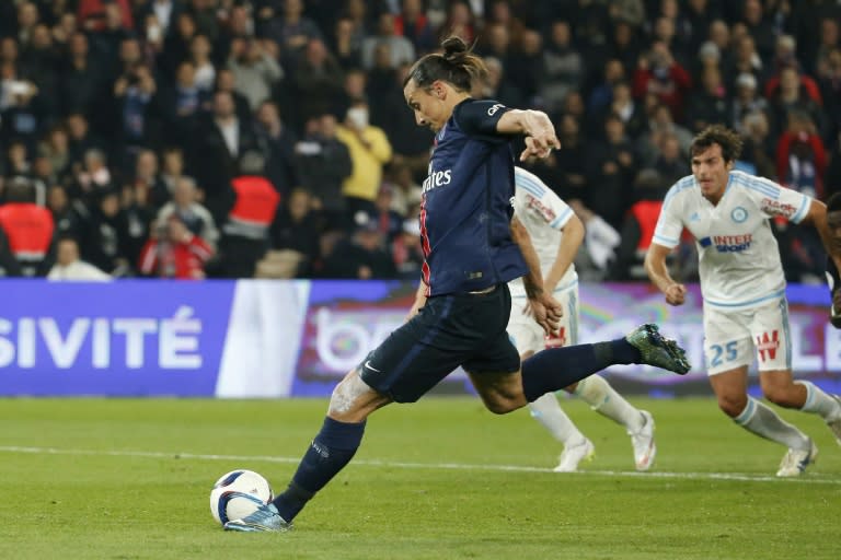 Paris Saint-Germain's forward Zlatan Ibrahimovic (C) kicks a penalty during a French L1 football match against Marseille on October 4, 2015 at the Parc des Princes stadium in Paris