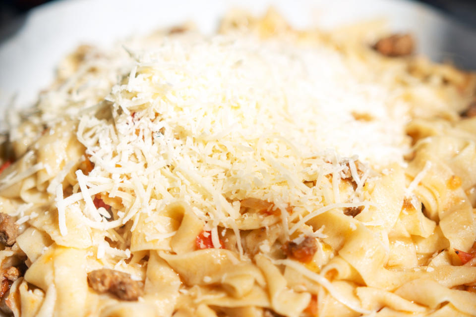 Close-up of a plate of pasta with grated cheese