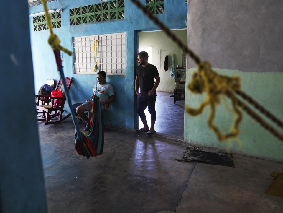 Migrants wait inside a local's home they are paying to stay in while waiting on the Mexican immigration office to accept their application for legal migration documents and give them "safe passage" permits in Tapachula, Chiapas state, Mexico, Monday, Oct. 3, 2022. A local taxi driver rents out space to migrants looking for lodging, for 100 pesos, or about $5 dollars a night. (AP Photo/Marco Ugarte)