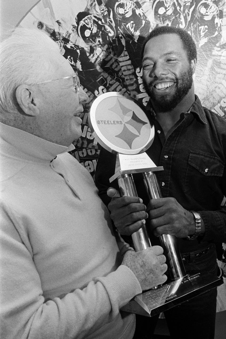 FILE - In this Dec. 16, 1980, file photo, Pittsburgh Steelers strong safety Donnie Shell, right, accepts the trophy for being named the Steelers' Most Valuable Player, from team vice president and chairman of the board Art Rooney, in Pittsburgh. Donnie Shell knew he was ahead of his time. It's why the Pittsburgh Steelers safety never worried about whether he'd get into the Hall of Fame. His long wait ended this week, when he got the call more than 30 years after playing his final game. (AP Photo/Gene Puskar, File)