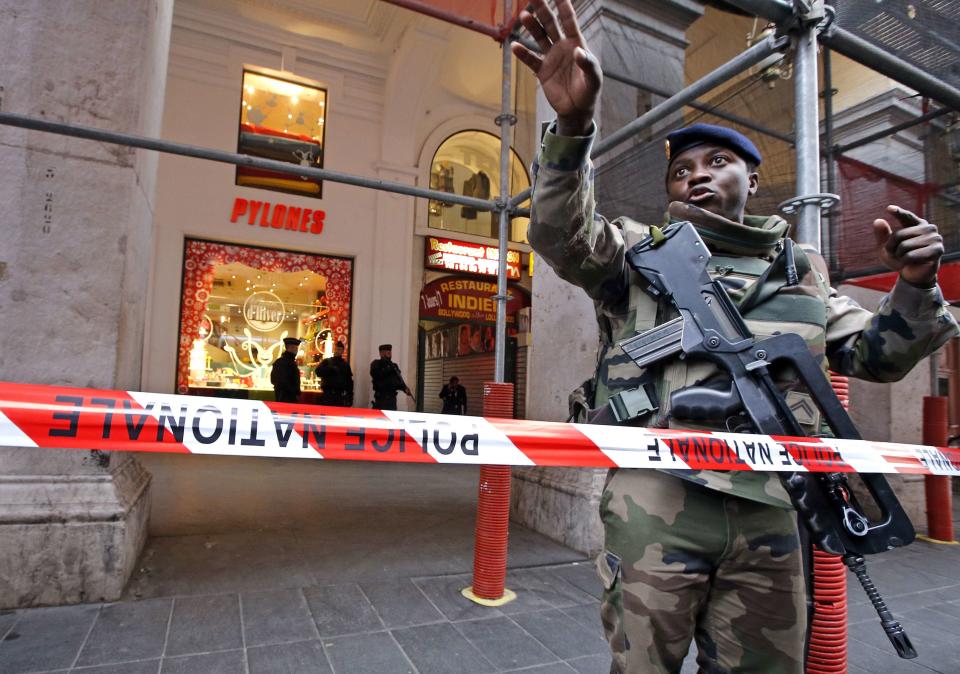 A French soldier gestures outside a Jewish Community center, where two French soldiers were attacked and wounded in a knife attack in Nice