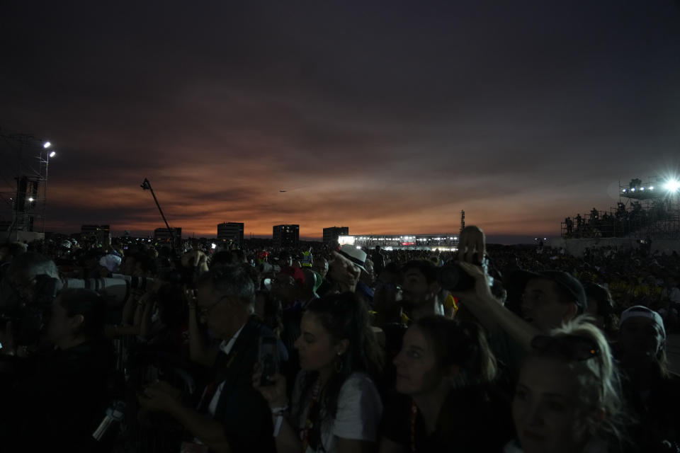 People gather at the Parque Tejo in Lisbon, Saturday, Aug. 5, 2023, for a vigil with Pope Francis ahead of the 37th World Youth Day. On Sunday morning, the last day of his five-day trip to Portugal, Francis is to preside over a final, outdoor Mass on World Youth Day – when temperatures in Lisbon are expected to top 40 degrees C (104F) – before returning to the Vatican. (AP Photo/Gregorio Borgia)
