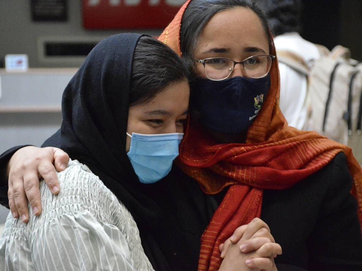 Families and friends were reconnecting in Saskatoon on Saturday, Sept. 10, 2022, when a group of Afghan refugees arrived at the airport. (Theresa Kliem/CBC - image credit)