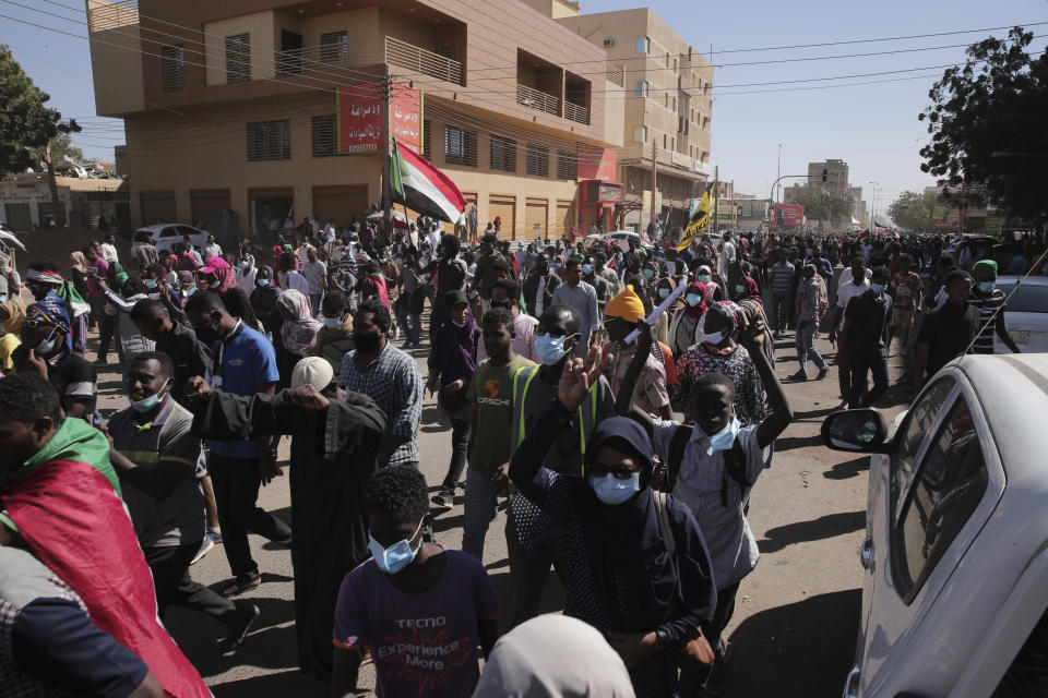 People march during a protest to denounce the October military coup, in Khartoum, Sudan, Thursday, Dec. 30, 2021. The October military takeover upended a fragile planned transition to democratic rule and led to relentless street demonstrations across Sudan. (AP Photo/Marwan Ali)