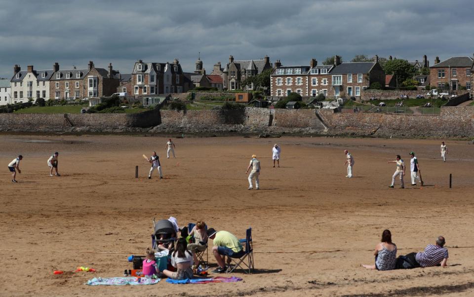  A view shows members of the Ship Inn Cricket Club, the only pub in Britain to have a cricket team with a pitch on the beach - REUTERS/Lee Smith