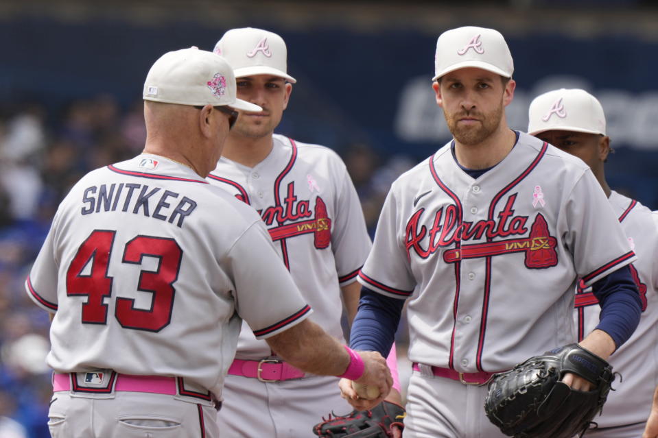 Atlanta Braves pitcher Collin McHugh, right, is taken out of the game by manager Brian Snitker (43) during the second inning of a baseball game against the Toronto Blue Jays in Toronto, on Sunday, May 14, 2023. (Frank Gunn/The Canadian Press via AP)